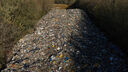 An 150 metre-long mountain of rubbish illegally dumped beside the A34 in Kidlington, Oxfordshire