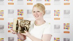 PGDE award winner Lorna holds her trophy - image
