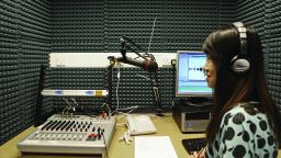 Journalism student recording in studio 23871