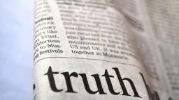 Section of newsprint with the word 'truth' in a headline