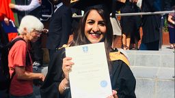 Sonia Nayyar in her graduation gown holding her degree certificate