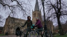 Bart and Barbara stand with their bicycles outside Chesterfield Church