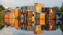 Houses reflected in the water during a flood