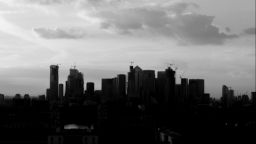 A black and white photo of the Alpha City skyline