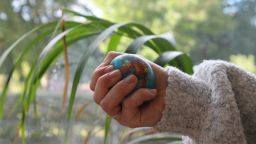 A student holds a stress ball with a globe pattern