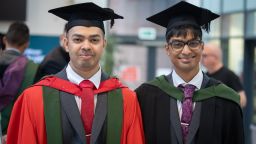 Nabhan and Madhi stood together wearing graduation gowns