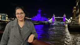 Photograph of Garima next to the River Thames in London