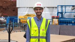 An image of our student Hasan Shwaish wearing a hi-vis vest and a hard hat as part of engineering student experience