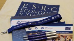 A pile of leaflets, pens and lanyards with White Rose Partnership branding 