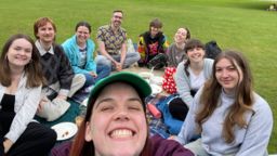 Students in a park. one Big smile in fron of the camera because this is a selfie