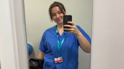 Biosciences graduate Tegan Fitch dressed for her placement in blue scrubs
