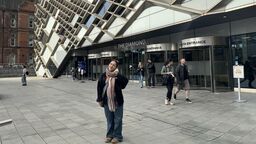 A person in front of The Diamond Building