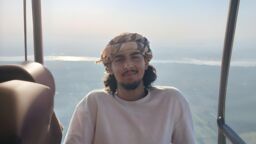 A person smiling with a landscape background