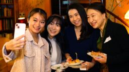 a group of alumni taking a selfie at a social in Hong Kong