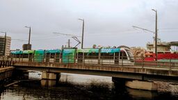 An electric tram going over a bridge