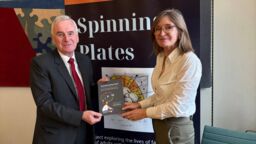 John McDonnell stood with Katherine Runswick-Cole in front of a banner which reads: Spinning Plates