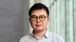 Portrait of academic with striped shirt and glasses 
