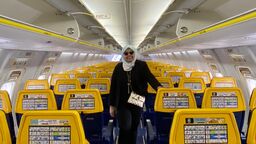Grantham Scholar Su Natasha Mohamad standing in the aisle of an airplane