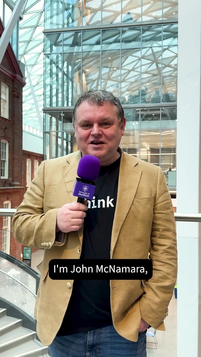 A man holding a microphone in the Heartspace Building