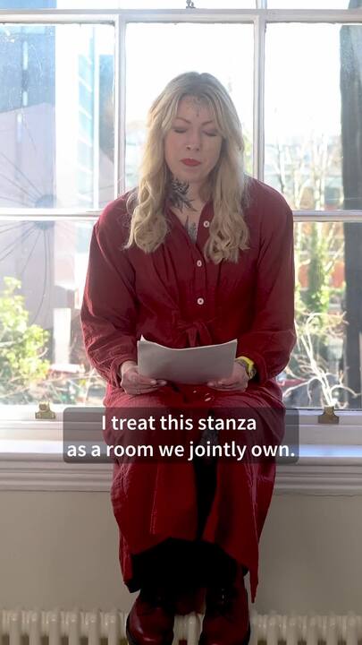 Helen Mort reading poem in a window frame 